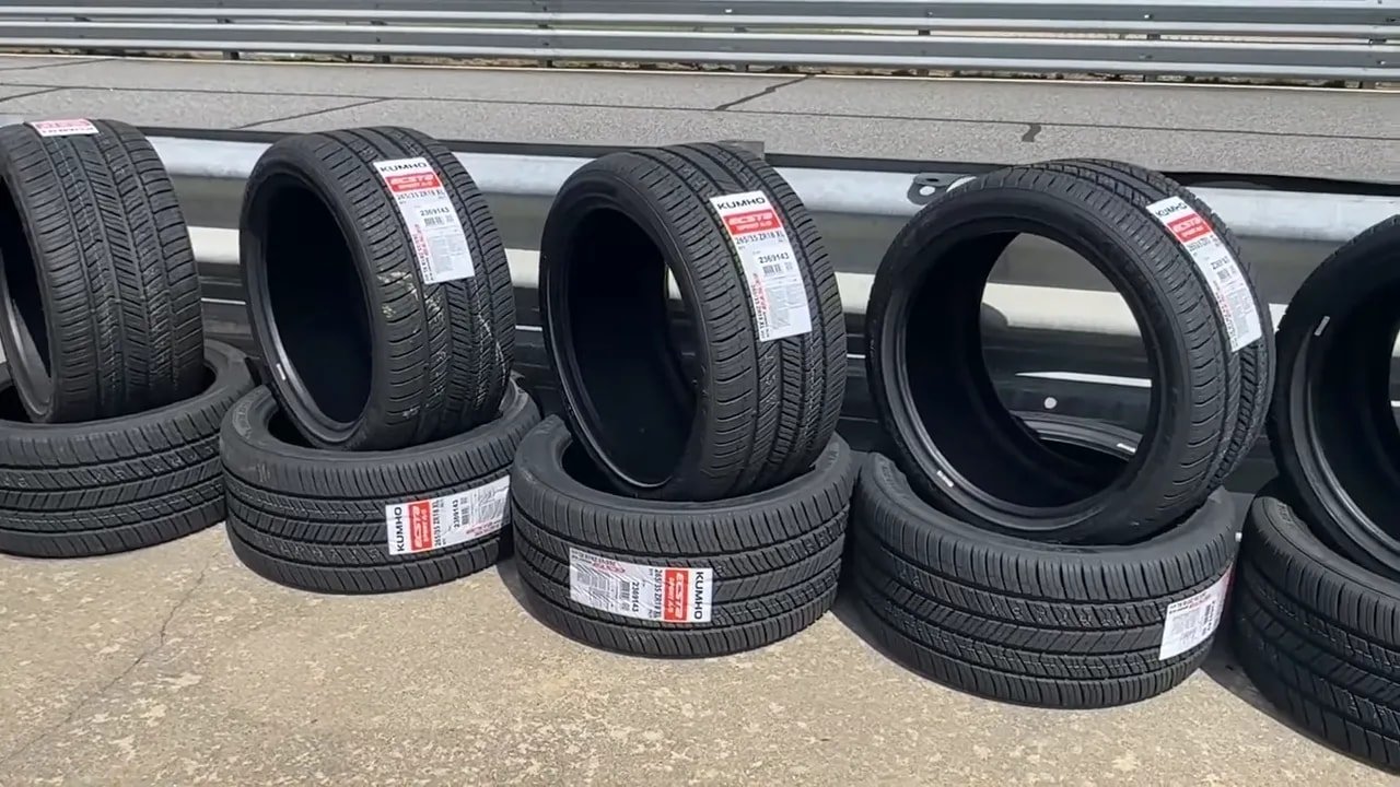 Close-up of four Kumho summer tires with tread pattern and sidewall labels on display